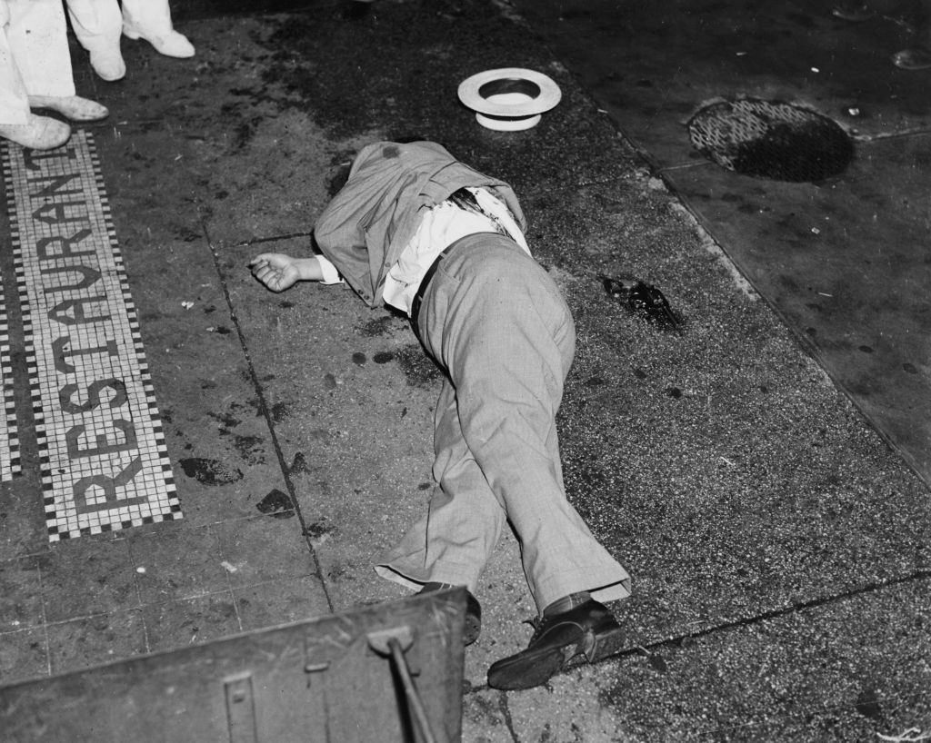 The body of gangster Dominick Didato on the sidewalk outside a restaurant on Elizabeth Street, New York, August 6, 1936