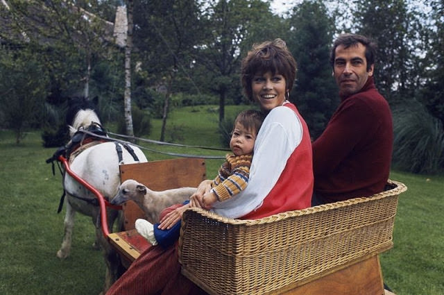 Jane Fonda with her husband Roger Vadim and daughter Vanessa in a cart pulled by a pony in the garden of their home