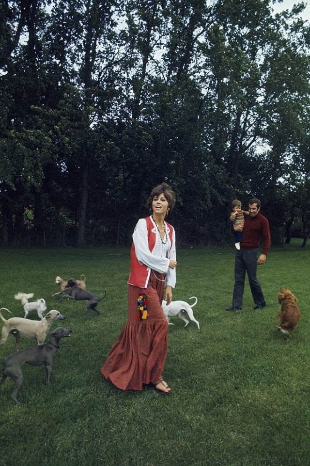Jane Fonda surrounded by dogs, in the garden with husband Roger Vadim and daughter Vanessa
