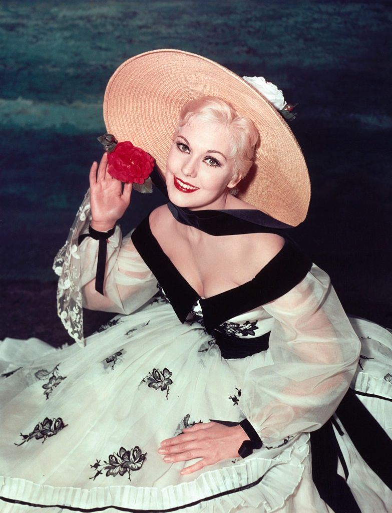 Kim Novak Wearing a Straw Hat and Floral Dress