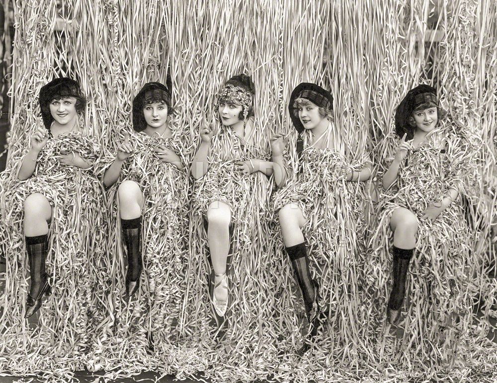 Five Mack Sennett girls provocatively posed amid serpentine confetti, Los Angeles, April 1918