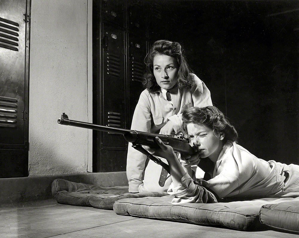 Training in marksmanship helps girls at Roosevelt High School in Los Angeles, August 1942