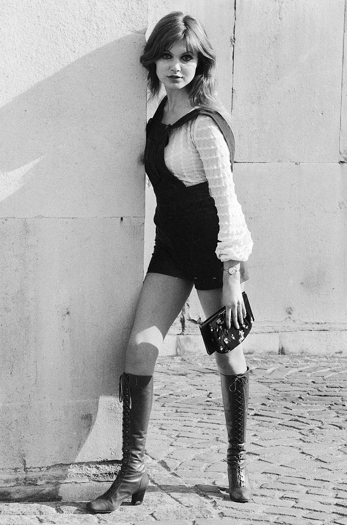 Madeline Smith poses wearing hot pants suit with knee high boots, 1971