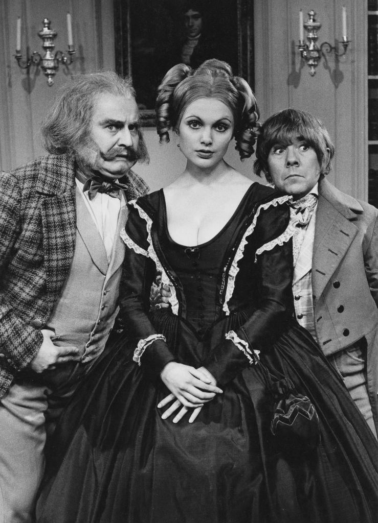 Madeline Smith with Ronnie Barker and Ronnie Corbett, wearing period costume in the 'classic serial' sketch from the television comedy series 'The Two Ronnies', 1971