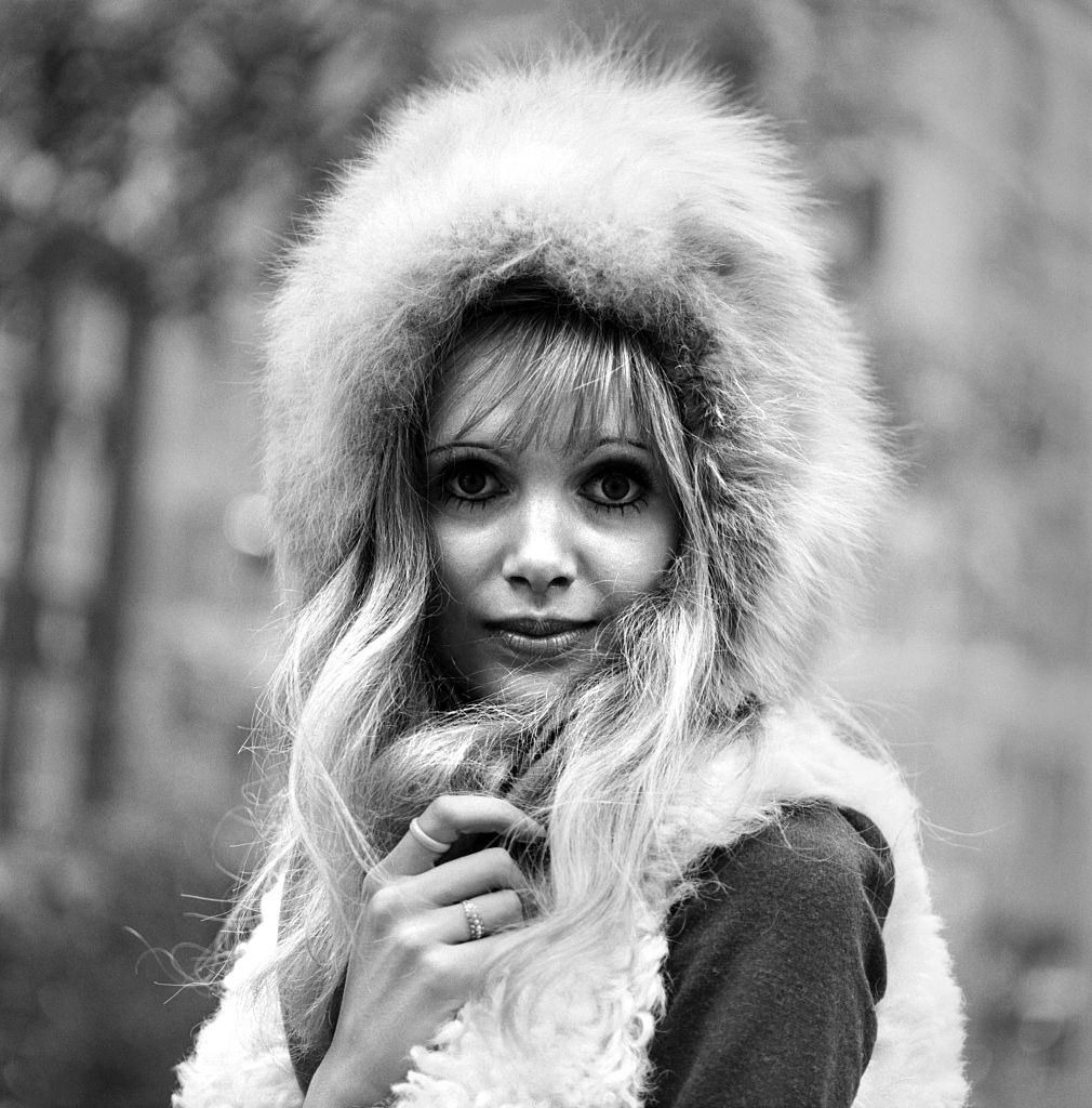 Madeline Smith aged 20 in London wearing a black dress and fur hood, 1969