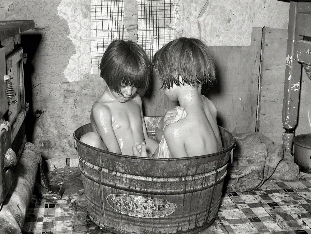 Children taking bath in their home in May Avenue community camp, Oklahoma City, July 1939