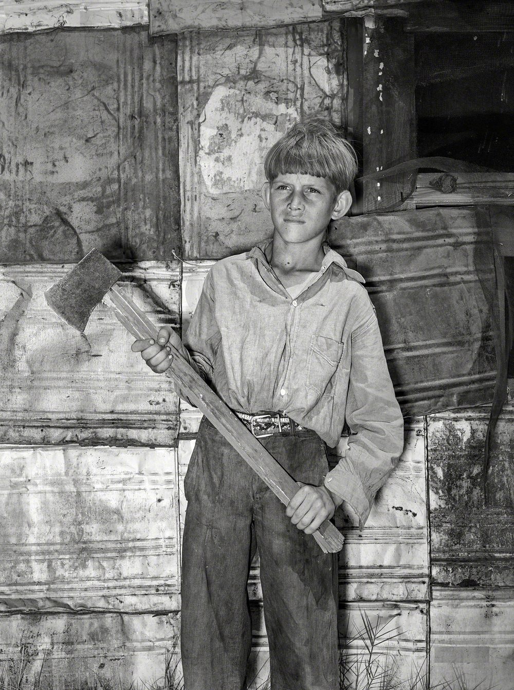 Boy living in May Avenue camp with homemade ax, Oklahoma City, July 1939
