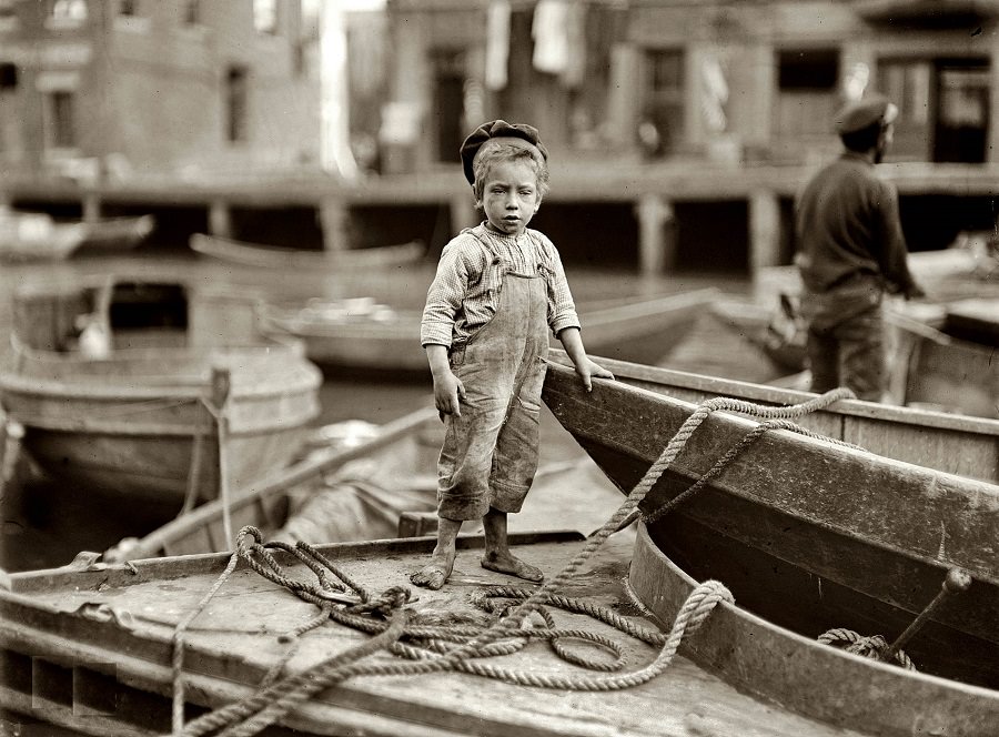 Truant hanging around boats in the harbor during school hours, Boston, 1909