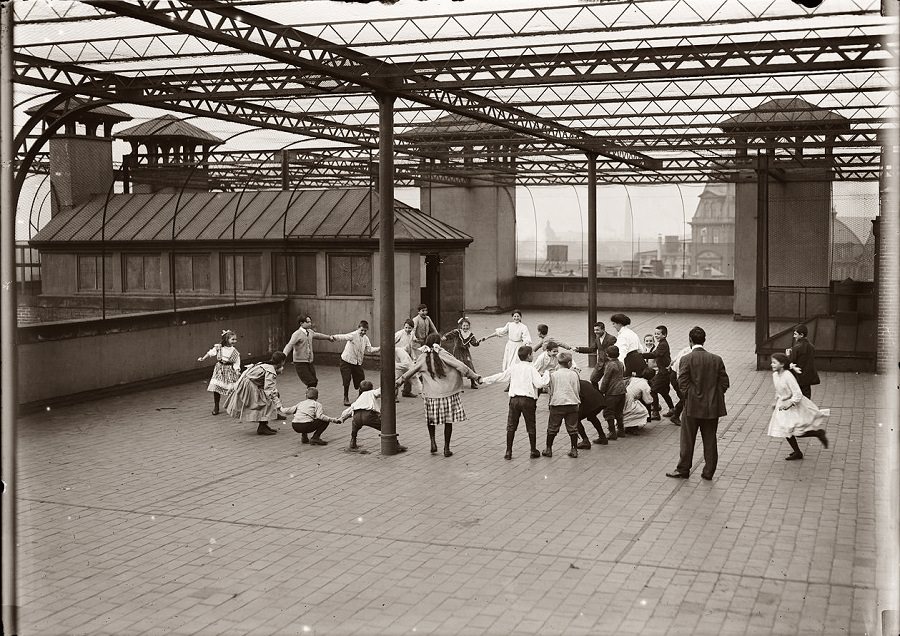 Immigrant children learning to play on the roof garden of the Washington School in Boston, 1909