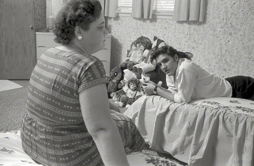 A young Elvis Presley at home in Memphis with mom Gladys, 1956