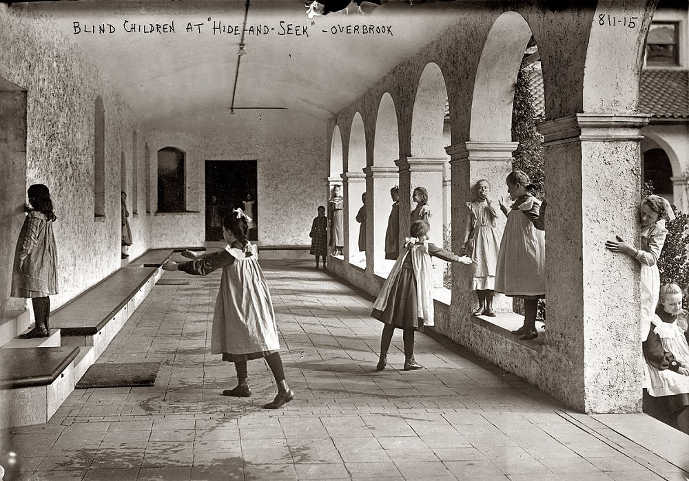 Blind children playing hide-and-seek among arcade pillars, at the Overbrook School in Philadelphia, 1912