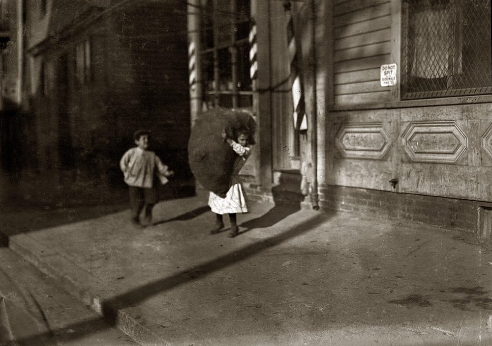 Spruce Street, Tiny girl with big bag she is carrying home, Providence, Rhode Island, November 1912