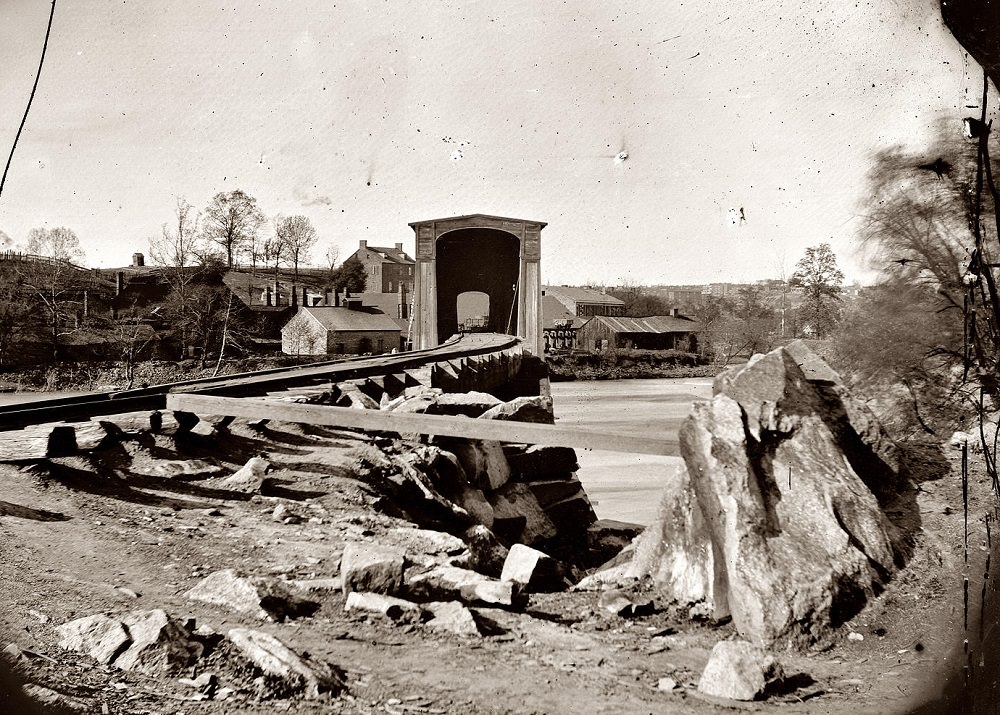 Belle Isle railroad bridge from the south bank of the James River after the fall of Richmond, Spring 1865