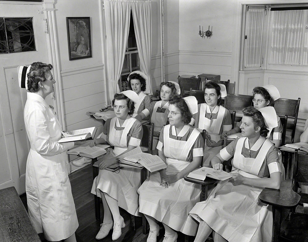 Shirley Babcock at right in the front listening to a lecture with other student nurses, Rochester, N.Y, September 1942