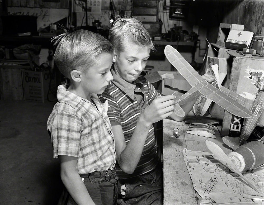 Earl and Howard Babcock looking over one of the model airplanes which Howard built, New York, September 1942