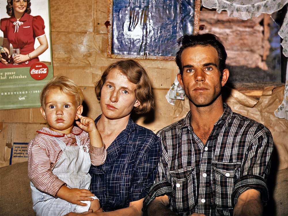 Jack Whinery with his wife and the youngest of his five children in their dirt-floor dugout home, Pie Town, New Mexico, Sep 1940