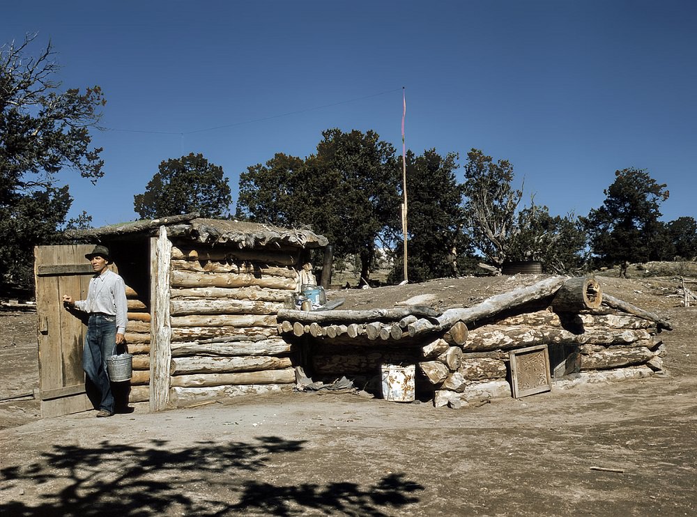 Mr. Leatherman coming out of his dugout home at Pie Town, New Mexico, October 1940