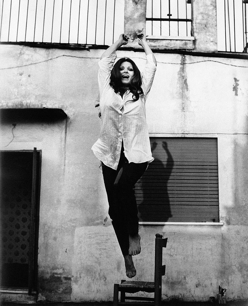 Italian actress Scilla Gabel jumping from a chair, 1960s