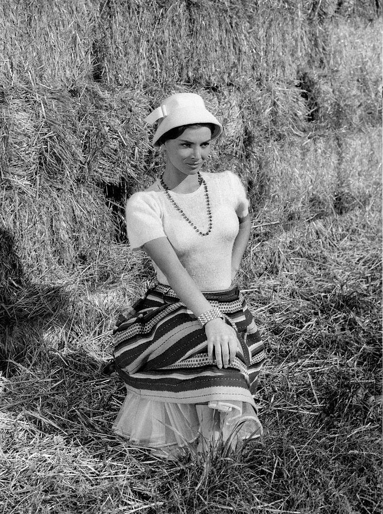 Scilla Gabel in front of Hay piles 1960s