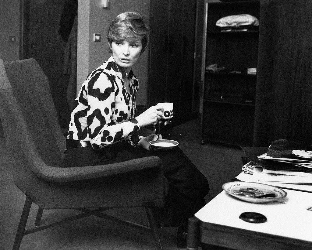 Scilla Gabel sitting in an armchair with a coffee-cup in her hands, Milan, 1970s