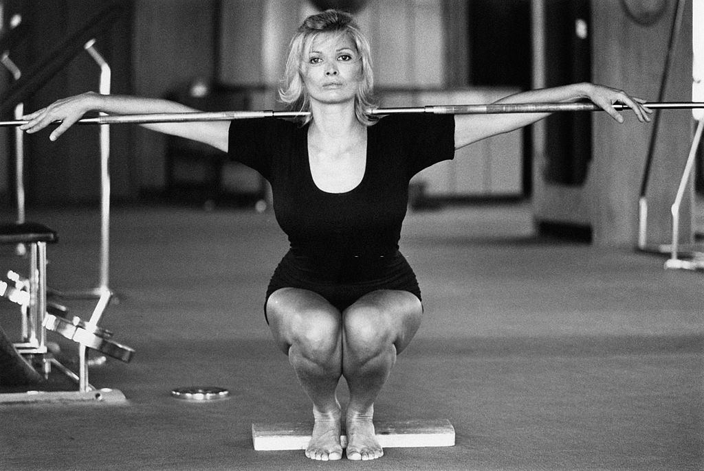 Scilla Gabel working out with a stick in a gym, Rome, 1970s