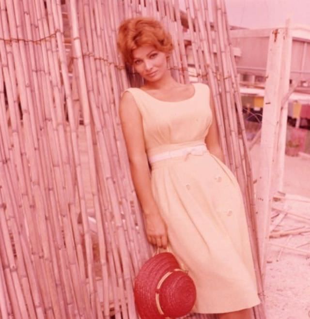 Scilla Gabel holding red hat, 1960s