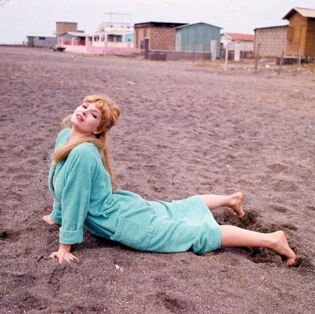 Scilla Gabel lying on the beach, 1960s