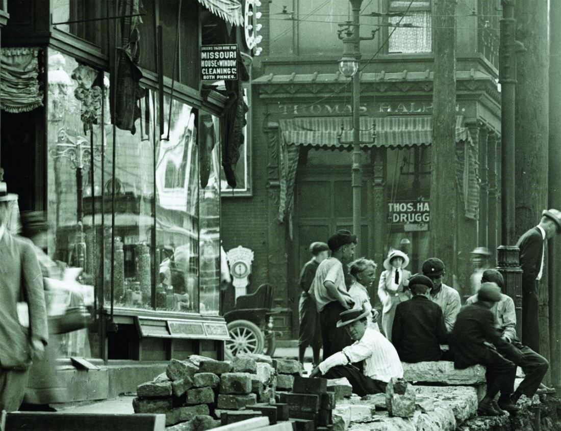 Bystanders observing street construction at the intersection of Grand Avenue and Olive Street, 1907