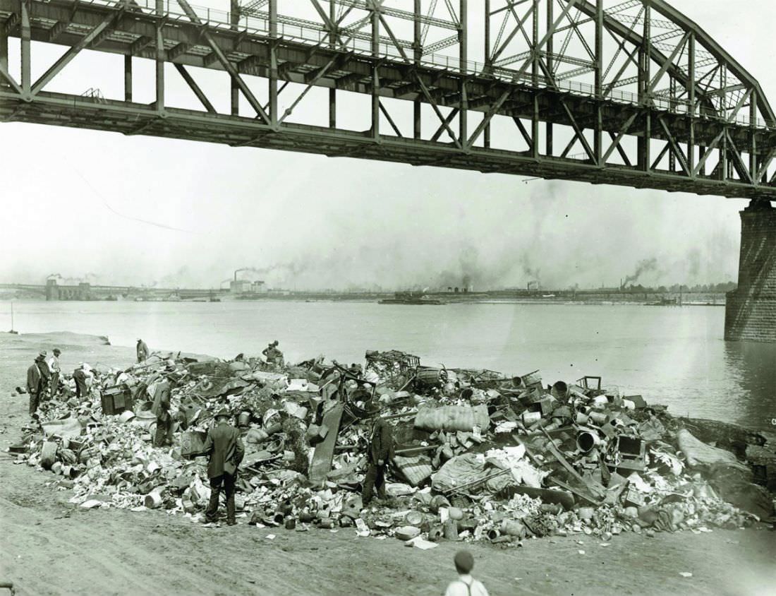 Men going through a rubbish pile on the riverfront south of Municipal Free Bridge, 1910