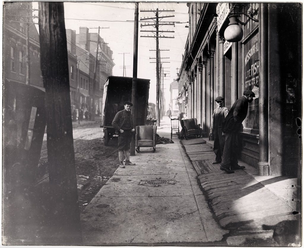 Movers pause for a break outside Harry Kram's Missouri-Illinois Live Fish Market, 1307 Biddle, ca. 1914–1924