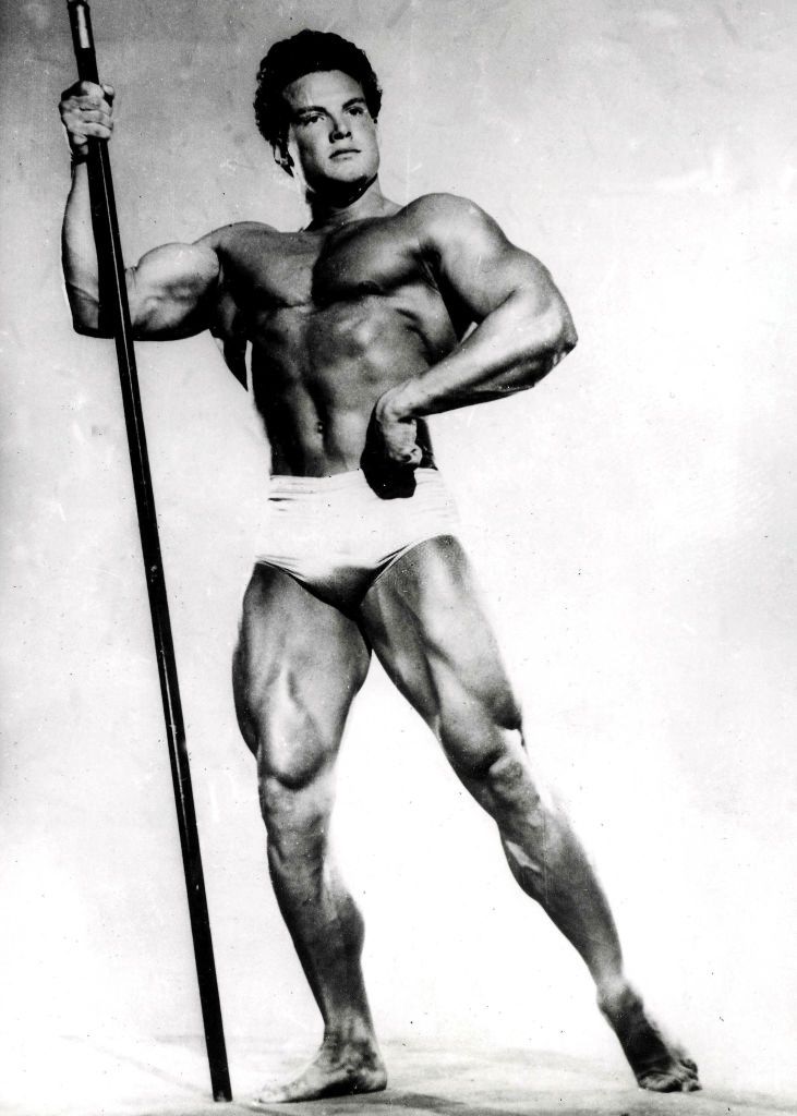 Steve Reeves, poses with a spear, 1947