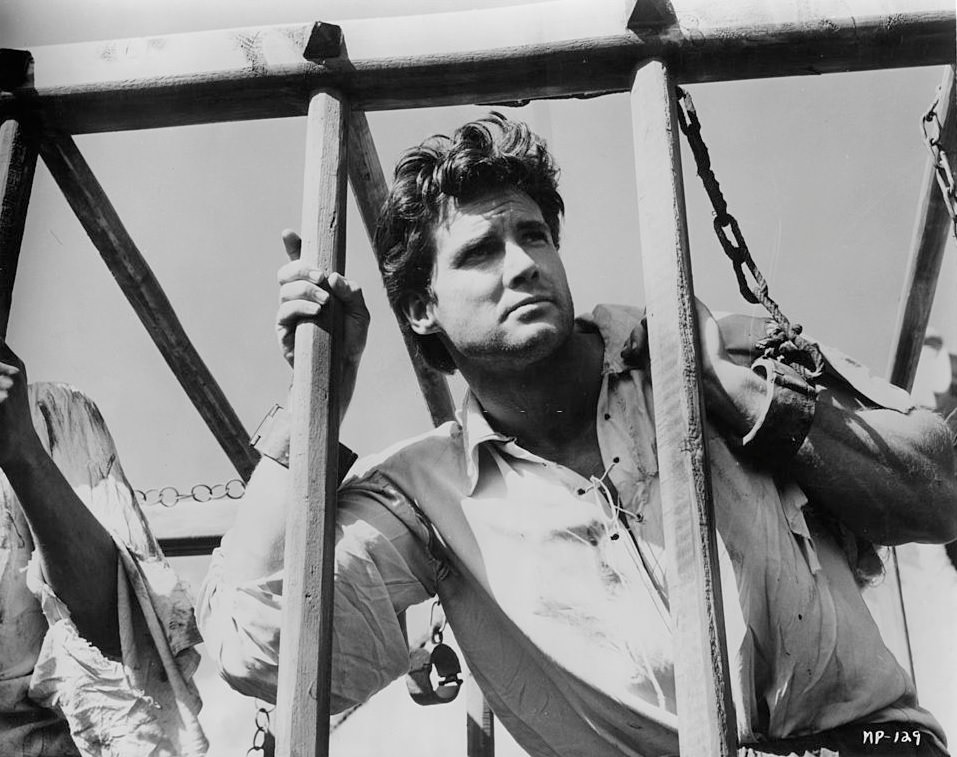 Steve Reeves shackled to bars in a scene from the film 'Morgan The Pirate', 1960