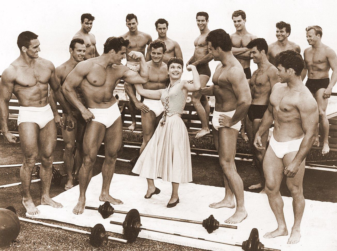 Steve Reeves with Debbie Reynolds and several other bodybuilders, 1954