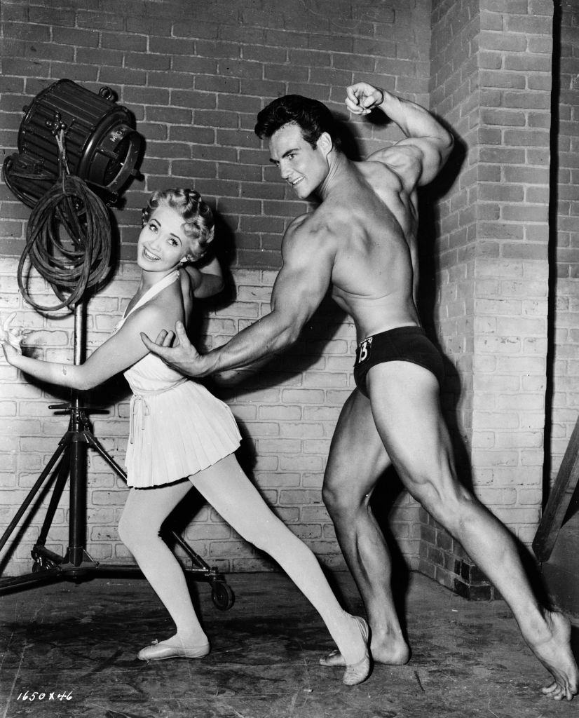 Steve Reeves with Jane Powell during the filming of Athena, 1954