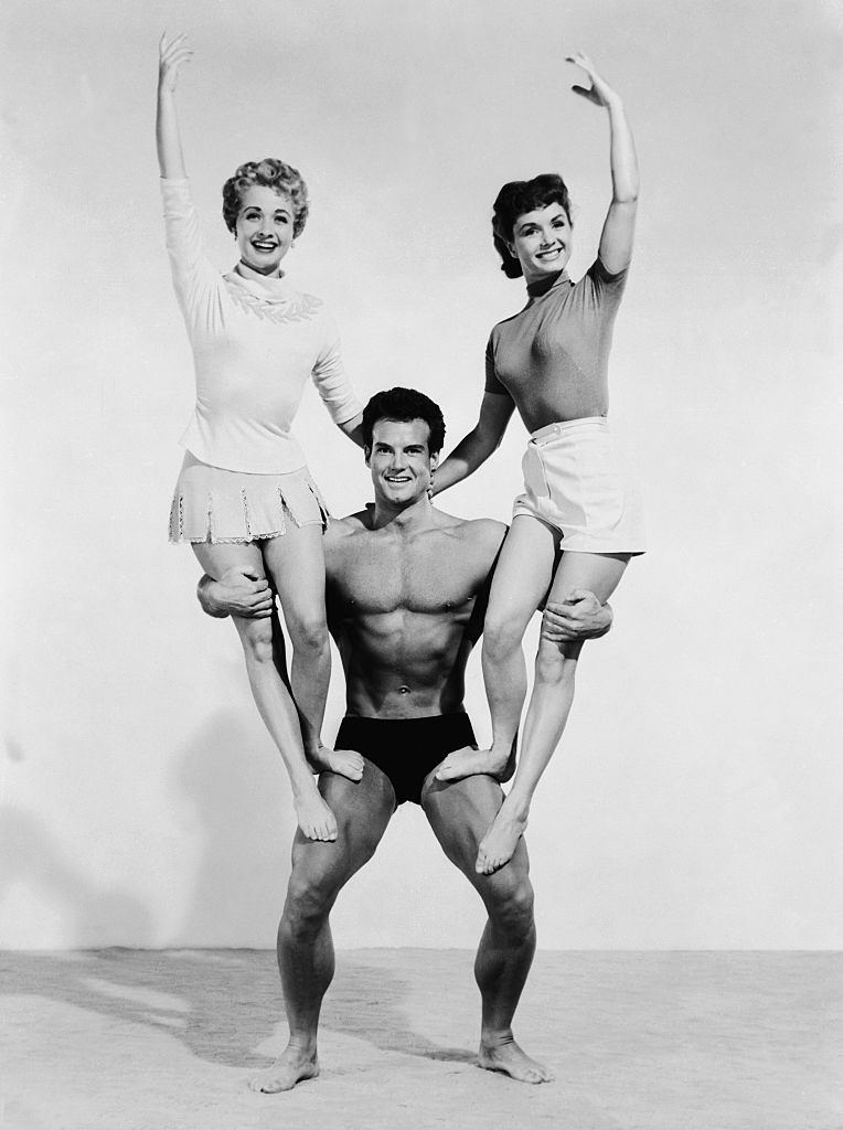 Steve Reeves holding Debbie Reynolds and Jane Powell, 1950s