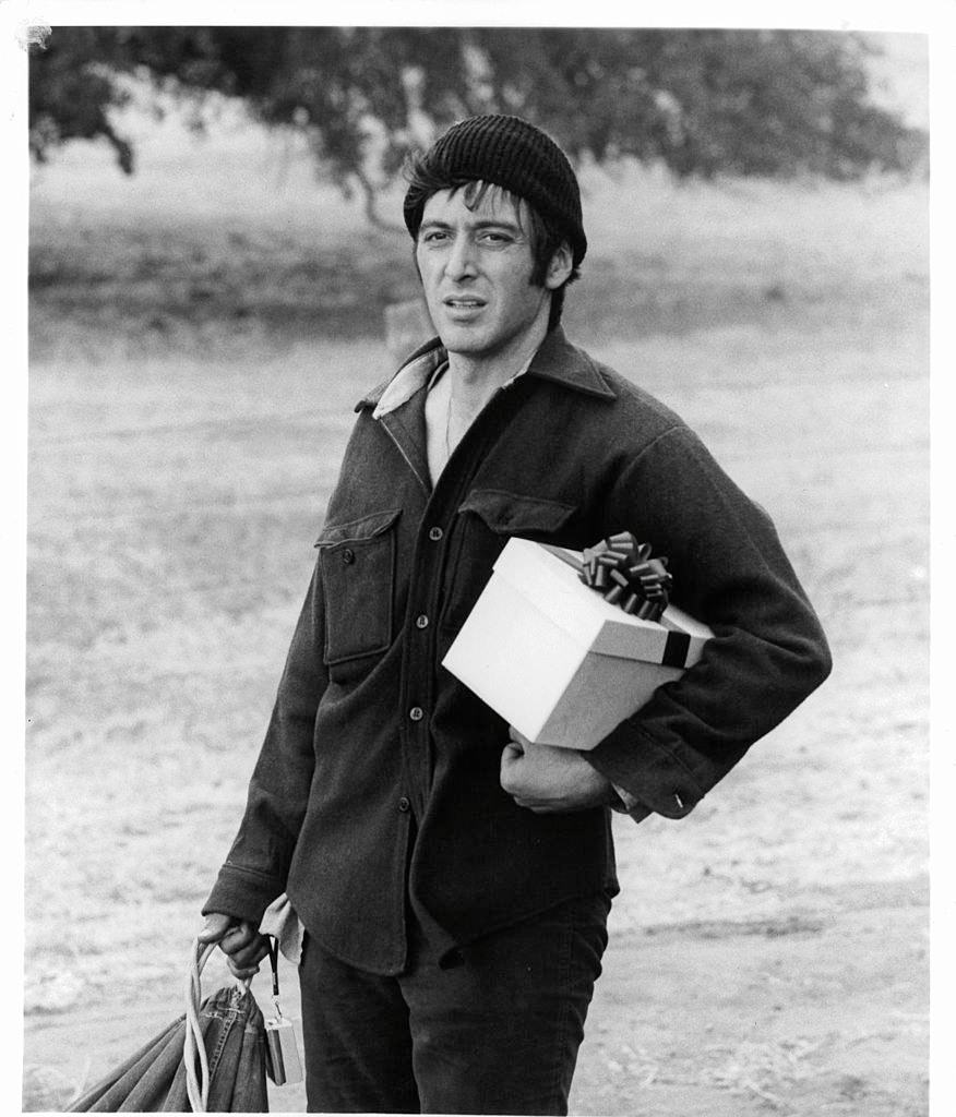 Al Pacino holding gift in a scene from the film 'Scarecrow', 1973.