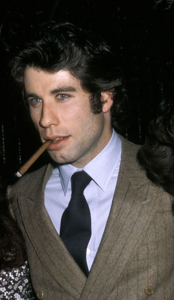 John Travolta smoking cigar at the 21 Club in New York City, 1979