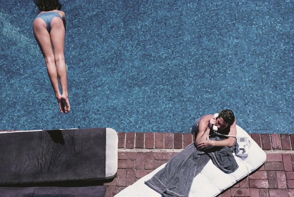 Richard Gere taking a call in his pool, 1982