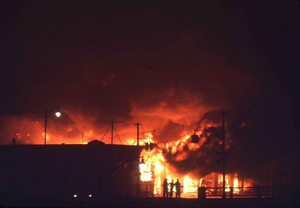 Nighttime view of fires, in the wake of ongoing riots, in the northwest part of town, Detroit, Michigan, 1967