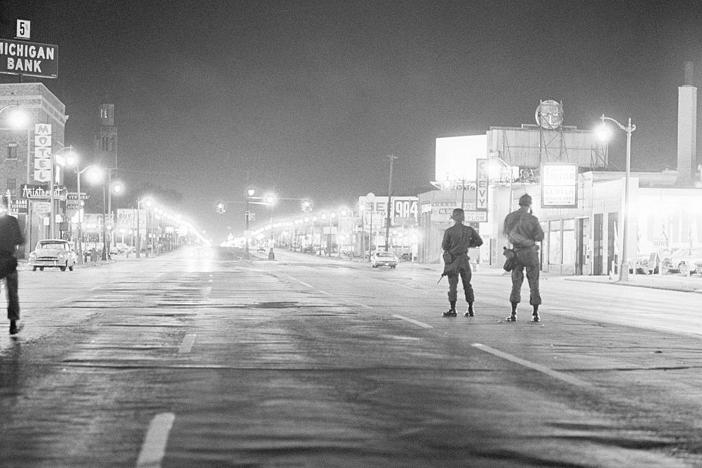 Soldiers patrol a street on Detroit's west side during a period of severe racial rioting, 1967