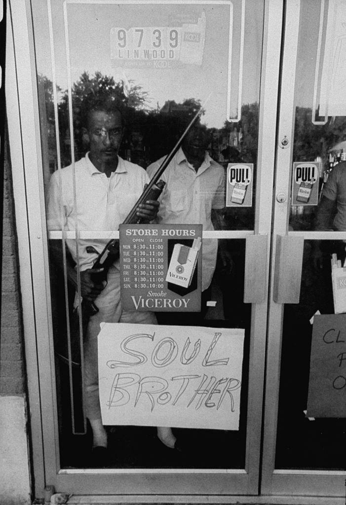 Soul Brother sign indicating African American ownership to store to keep looters away during Detroit race riots, 1967