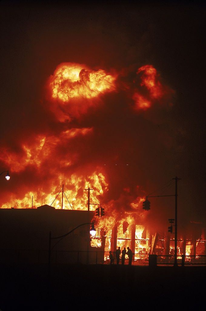 Building burning during race riots in the city, 1967