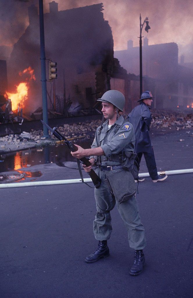 National Guardsman patroling street after race riots, 1967