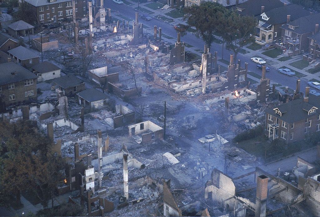 Smoke lifting from burnt out buildings in aftermath of race riots, 1967