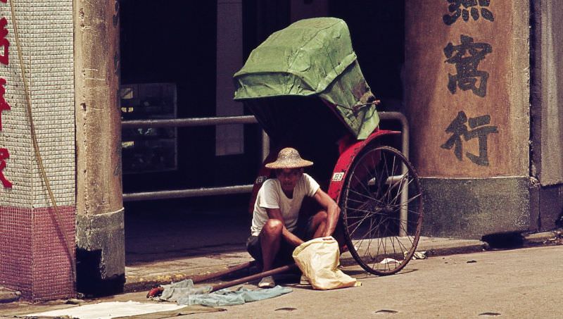 Man sitting by his rickshaw, 1970s