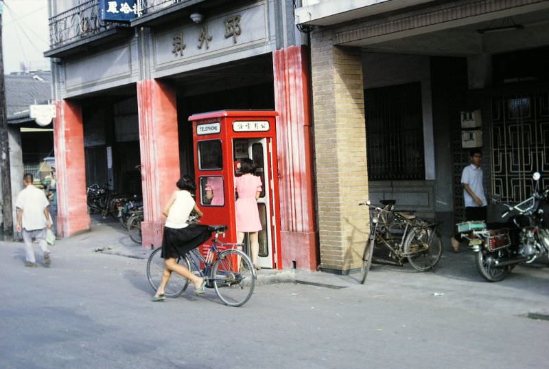 Telephone booth with twins phoning, 1970s