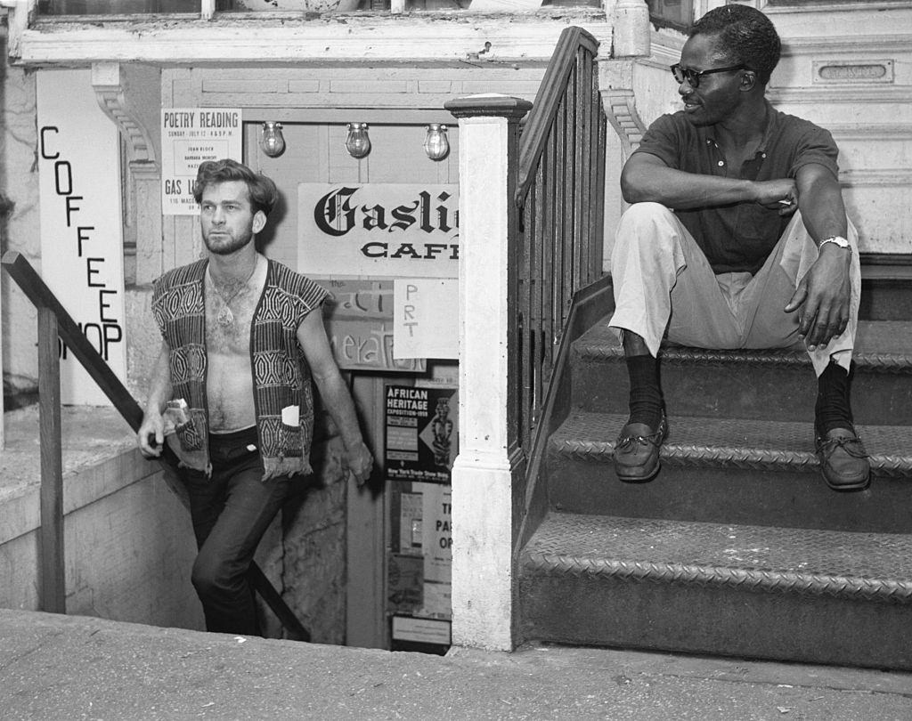 In the world of the beatnik, Dick Woods walks up the steps of the Gaslight Coffee Shop in New York's Greenwich Village, 1959