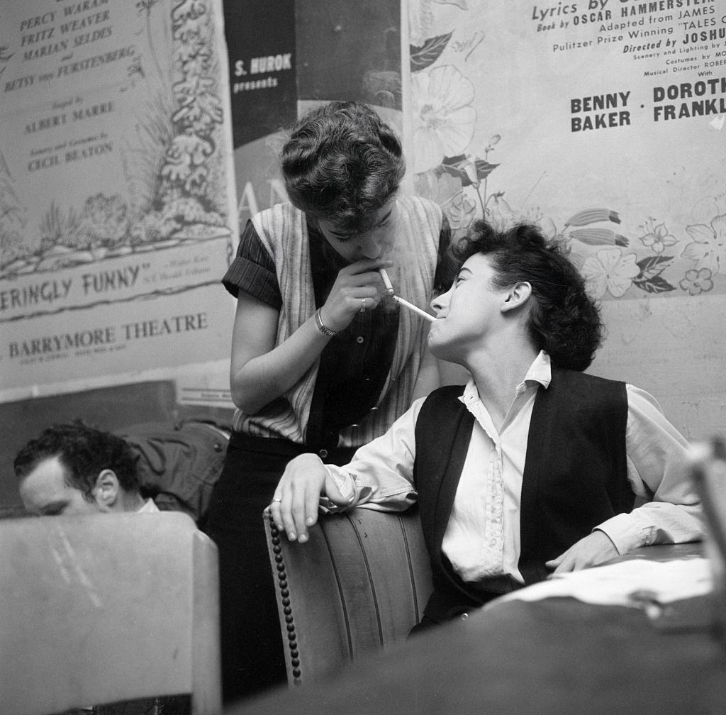 Beatniks at the Cock N' Bull lighting cigarettes off each other, 1959