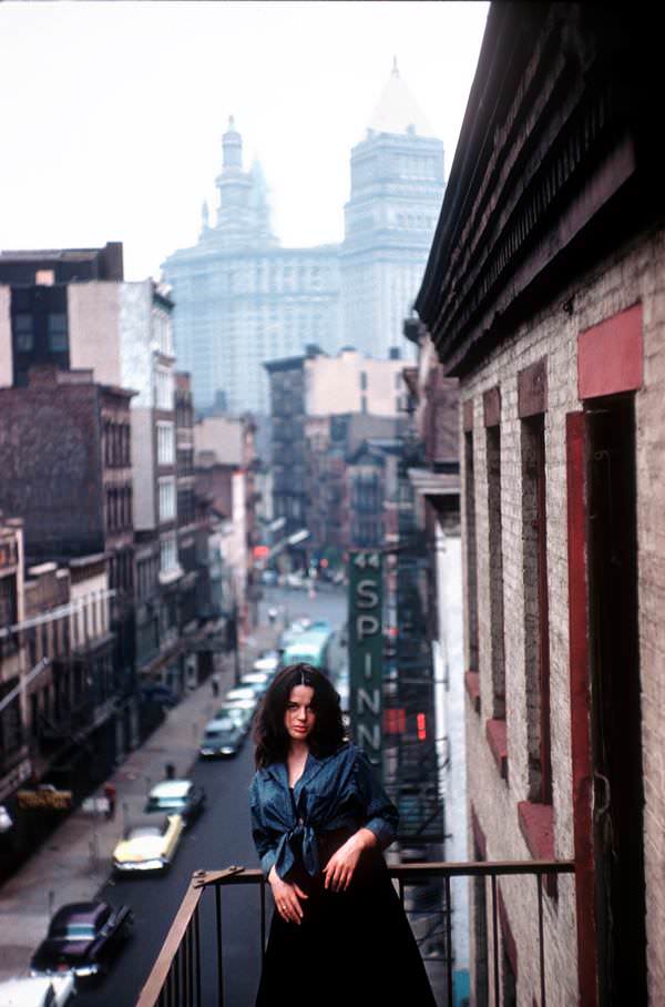 Mimi Margaux, who described herself as a "dancer, actress, model and follower of 'la Vie Boheme,'" enjoys the view from the balcony in an East Village hangout in 1959.