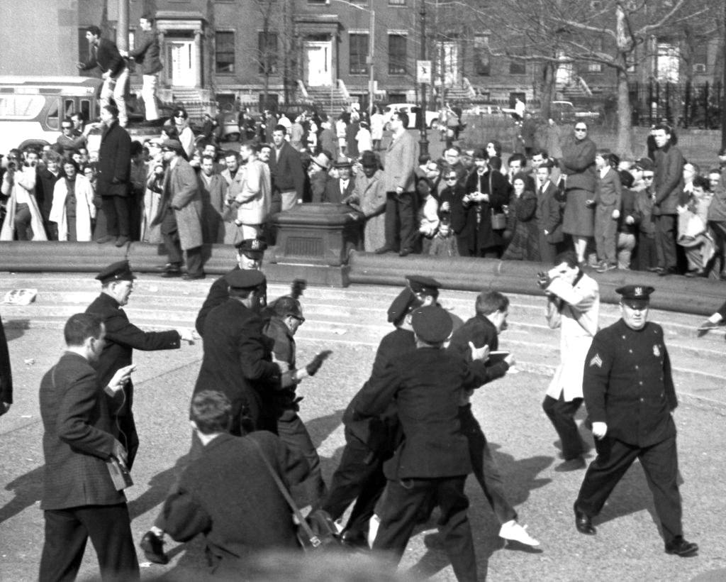 Police officers arrest beatniks demonstrators in Washington Square Park during a march, April 9, 1961.